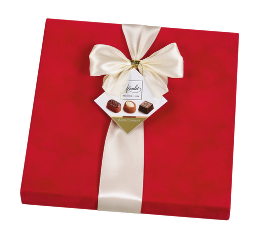 Red velvet praline gift box side view with cream ribbon and Belgium label