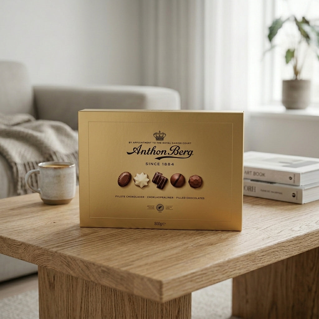 Anthon Berg gold chocolate box with assorted pralines on wooden table