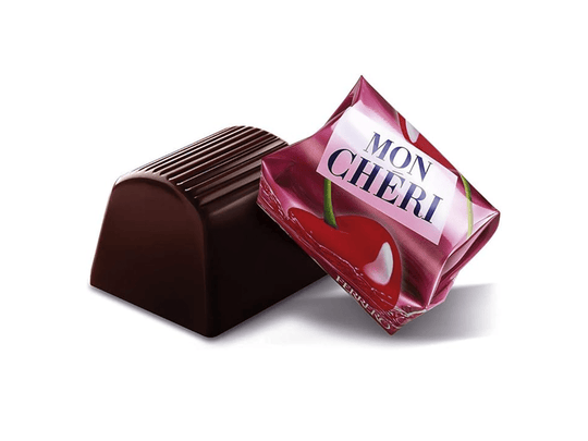 Mon Chéri körsbärslösningschoklad bit med räfflat tak bredvid rosa förpackning