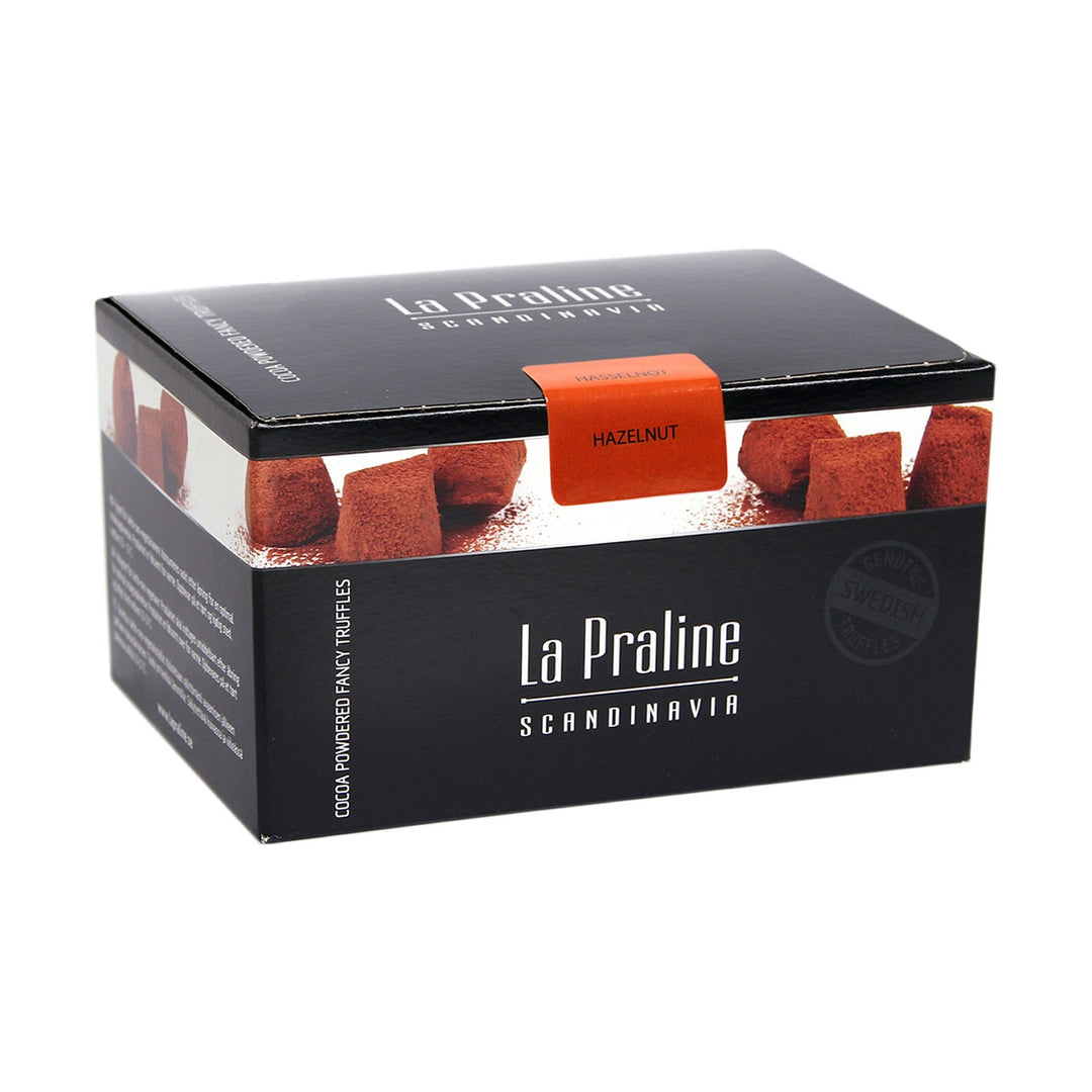 Chokladshopen La Praline hasselnötstryfflar i en elegant svart presentask pudrade med kakao
