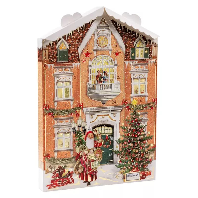 HEILEMANN julkalender i form av rött tegelhus med snö och julpynt, fylld med mjölkchoklad